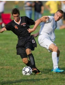 SHS Center Midfielder Joey Schinella dribbles past Trinity defender in the Black Knights' 4-0 win over Crusaders.