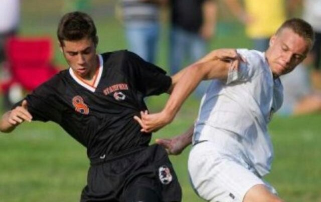 SHS Center Midfielder Joey Schinella dribbles past Trinity defender in the Black Knights 4-0 win over Crusaders.