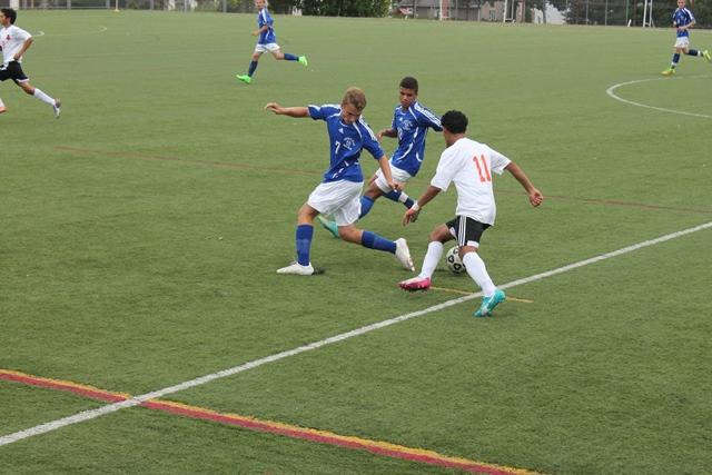 Senior+Luis+Maradiaga+taking+on+two+Fairfield+Ludlowe+defenders.