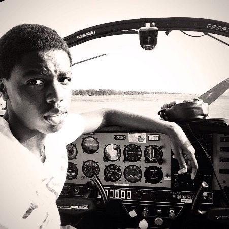 11th grader Ilvien Junior Middy in the cockpit of a plane he flies