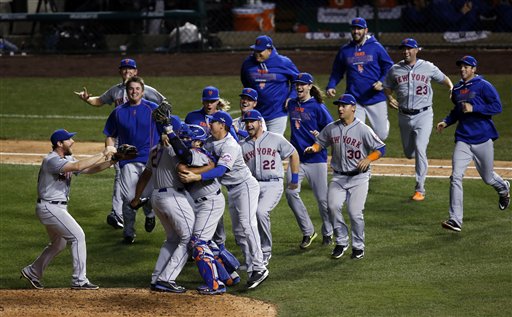 The New York Mets celebrate after Game 4 of the National League baseball championship series against the Chicago Cubs Wednesday, Oct. 21, 2015, in Chicago. The Mets won 8-3 to advance to the World Series. (AP Photo/Charles Rex Arbogast)