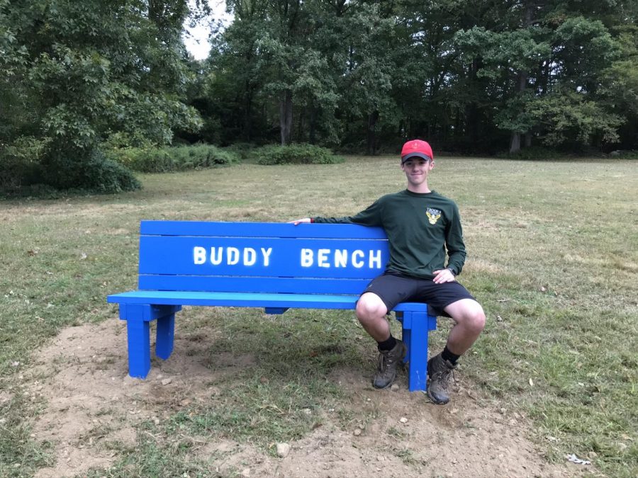 Nathanson poses with installed bench at Newfield Elementary