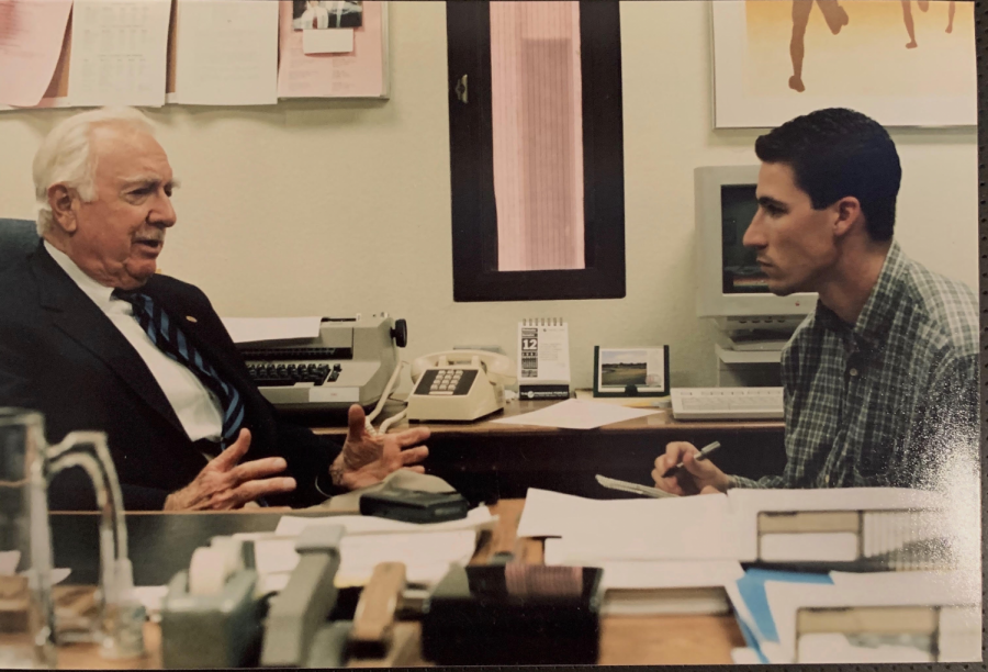A younger Passamano speaks to journalism icon Walter Cronkite at Arizona State University.