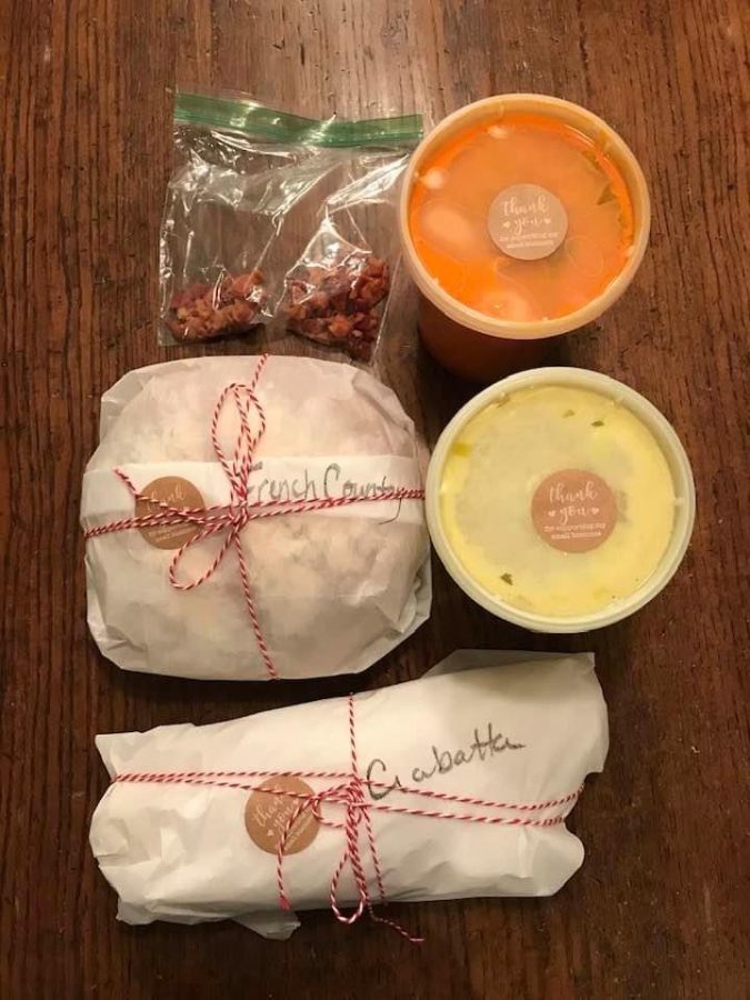 Packaging of potato leek corn chowder with a side of bacon, tomato bisque soup, ciabatta, and French country loaf